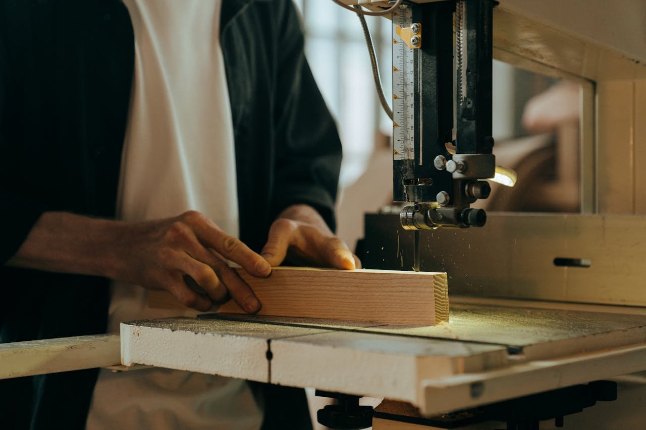 about-02 A craftsman skillfully working with wood in an indoor workshop setting.