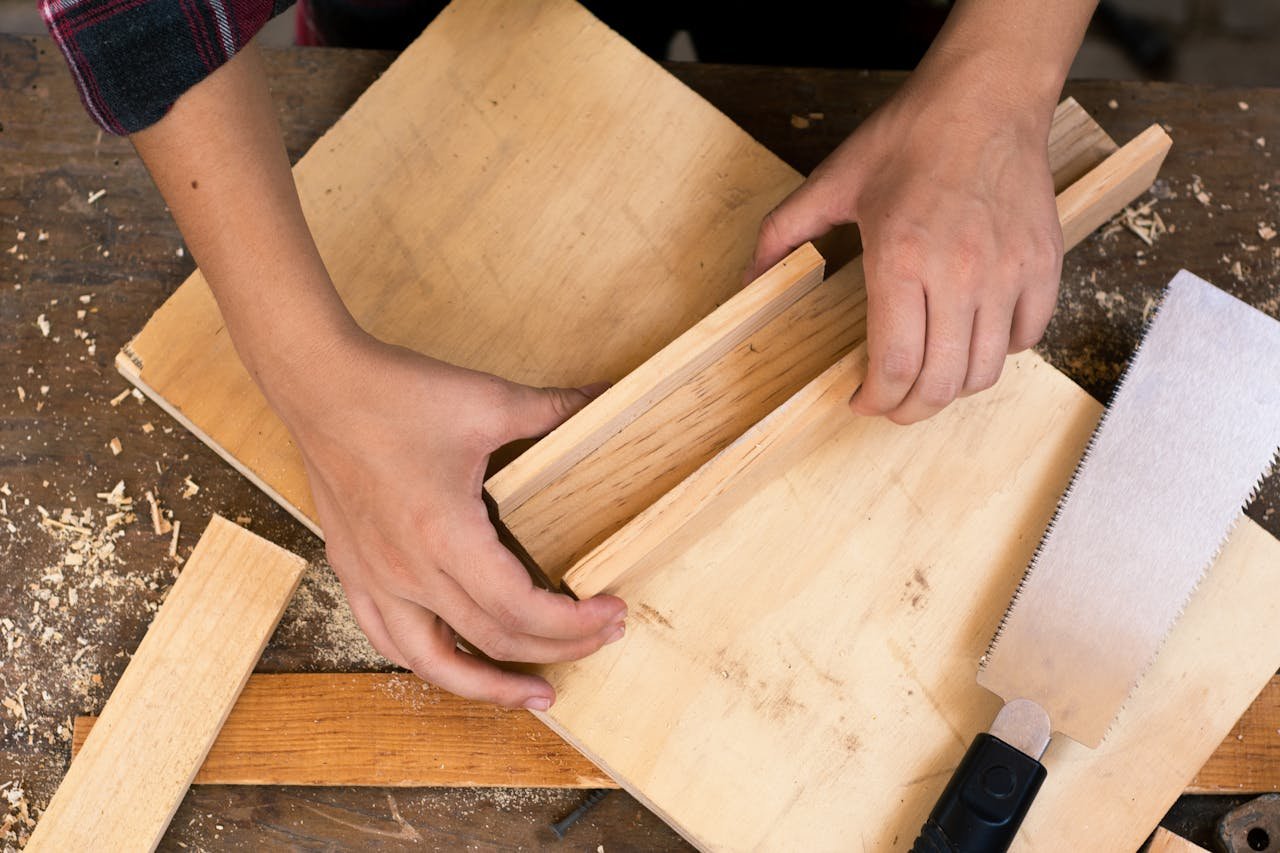 why-choose-us Close-up of hands crafting wood with tools, perfect for DIY carpentry and craft projects.